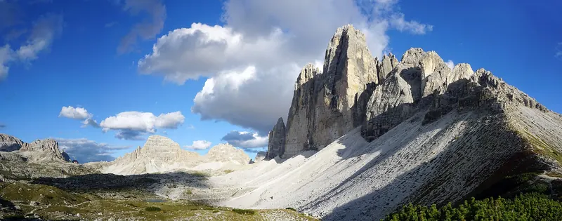 A wide panorama of the three towers of the Tre Cime di Lavaredo above their scree basin