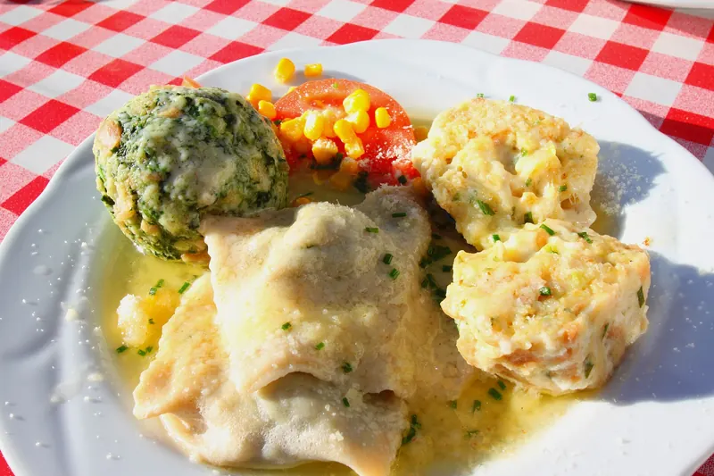 A trio of canederli — bread dumplings studded with spinach, speck and cheese