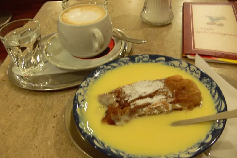 Apfelstrudel served with a jug of vanilla sauce