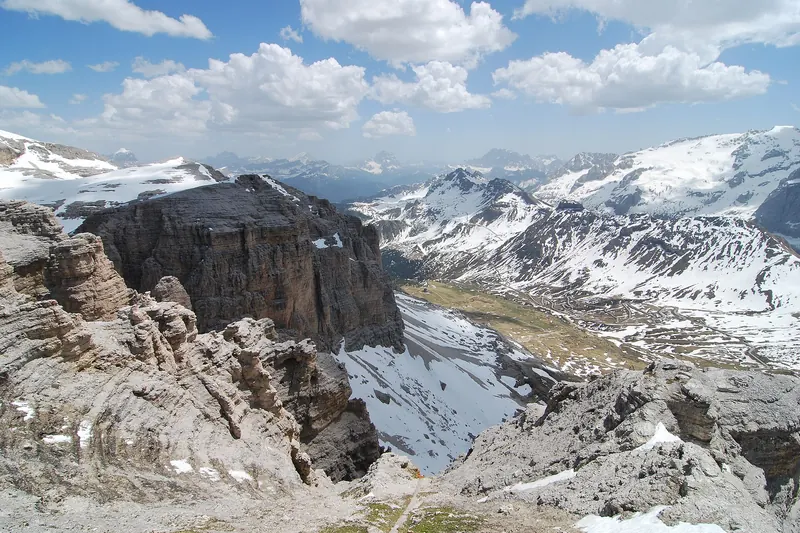 A cable car climbing above the Dolomites