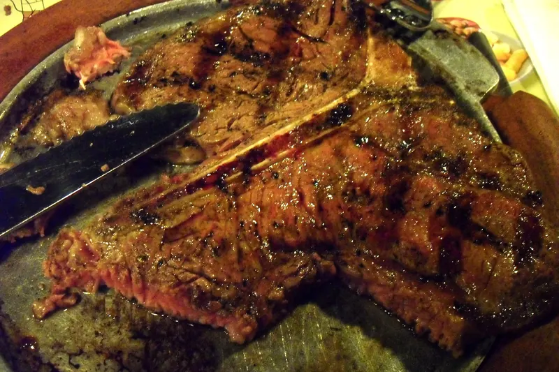 A thick T-bone bistecca alla fiorentina, grilled blue-rare