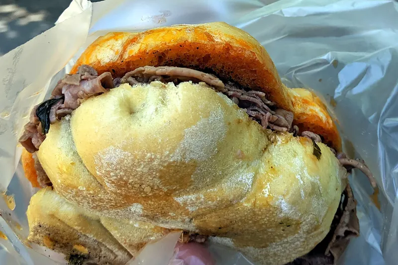 A lampredotto sandwich, its roll dipped in the cooking broth