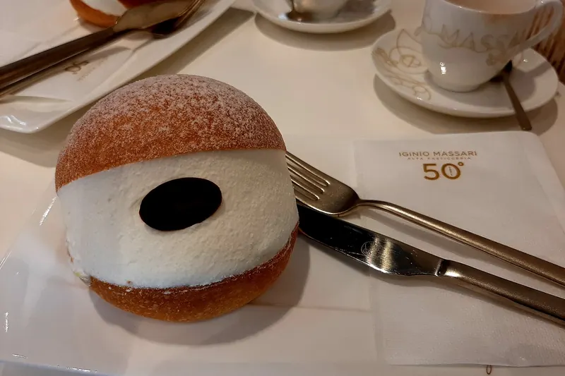 A maritozzo bun split and overfilled with whipped cream