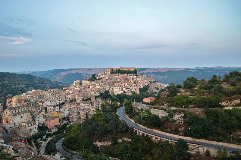 Ragusa Ibla at dusk, its Baroque churches and rooftops lit gold