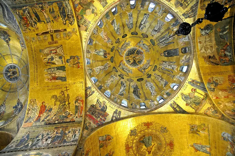 Gold-ground Byzantine mosaics covering a domed vault inside St Mark's Basilica