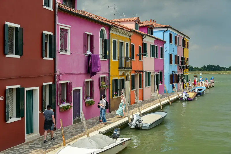 A canal lined with brightly painted houses on the island of Burano