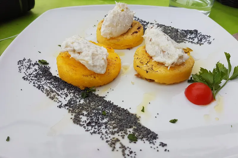 Whipped baccalà mantecato spread over grilled white polenta