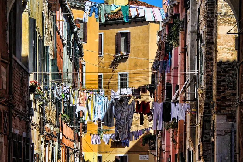 A narrow Venetian calle strung with laundry between old buildings