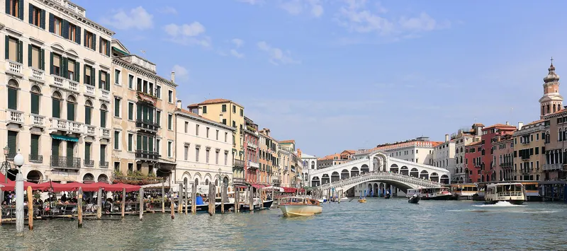 The Grand Canal curving past palace facades towards the Rialto Bridge in Venice