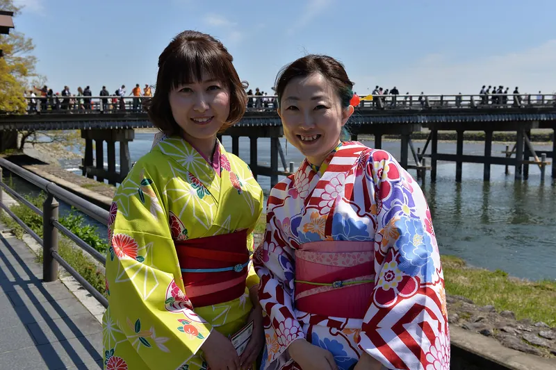 Visitors dressed in kimono at Arashiyama's Togetsukyo bridge