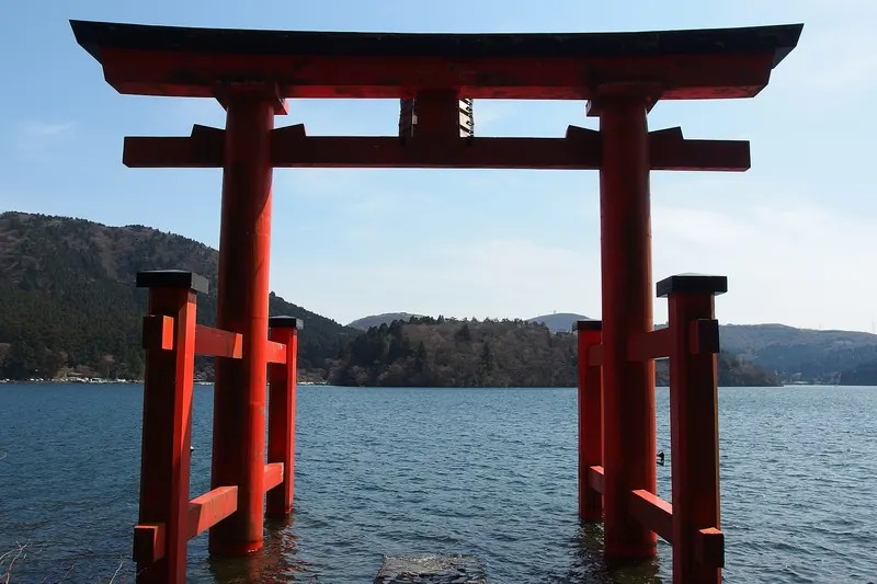 Hakone Shrine's red torii gate standing in Lake Ashi