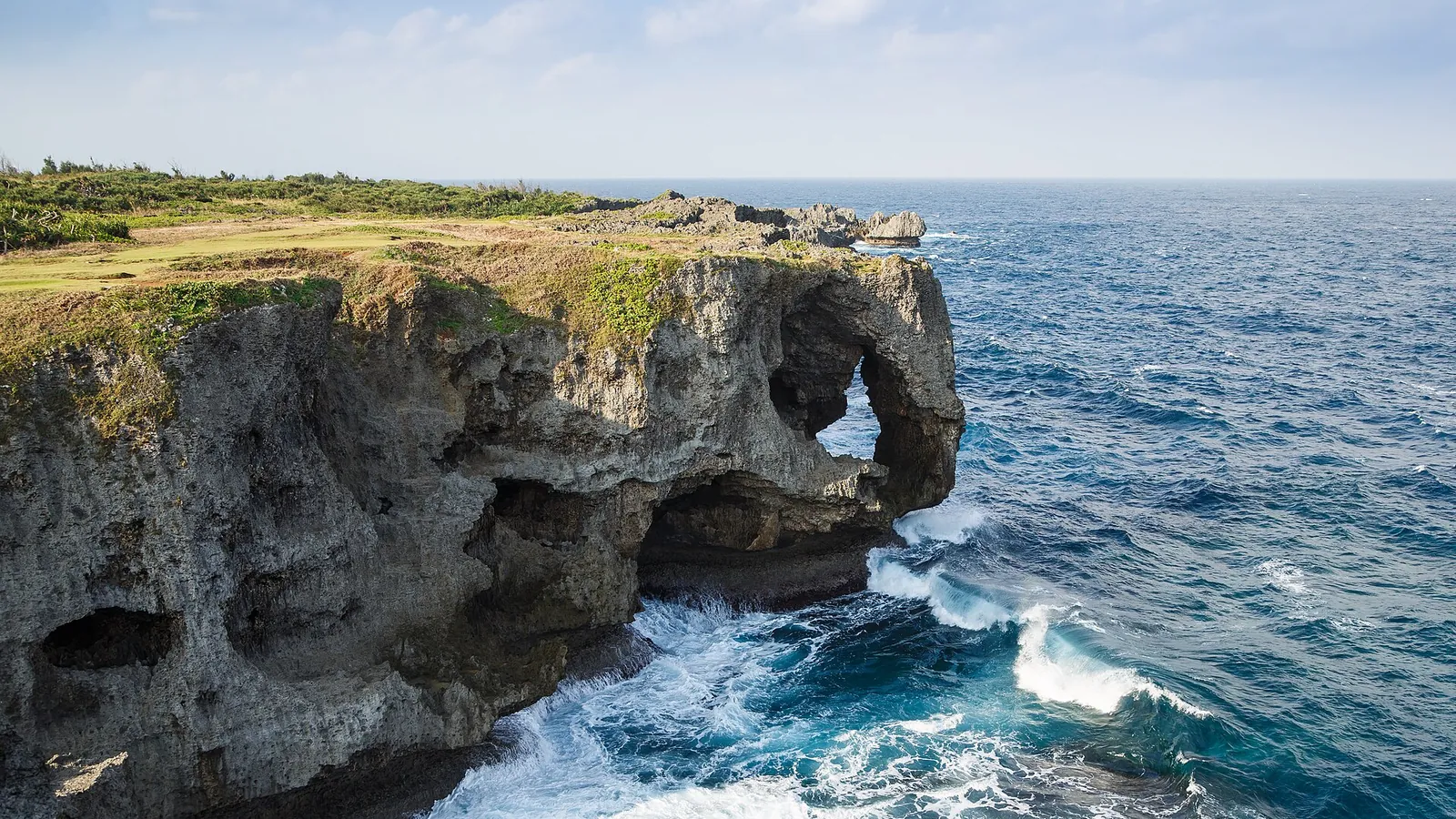 Cape Manzamo's dramatic cliff dropping into turquoise water on Okinawa's coast