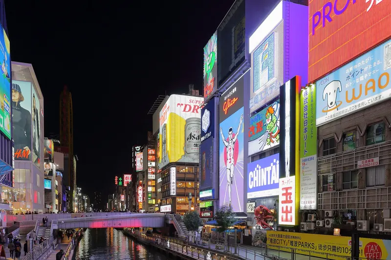 Dotonbori's neon signage over the canal at night