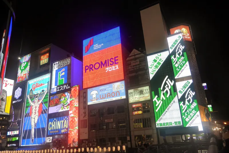 Dotonbori's neon signs reflected in the canal at night in Osaka