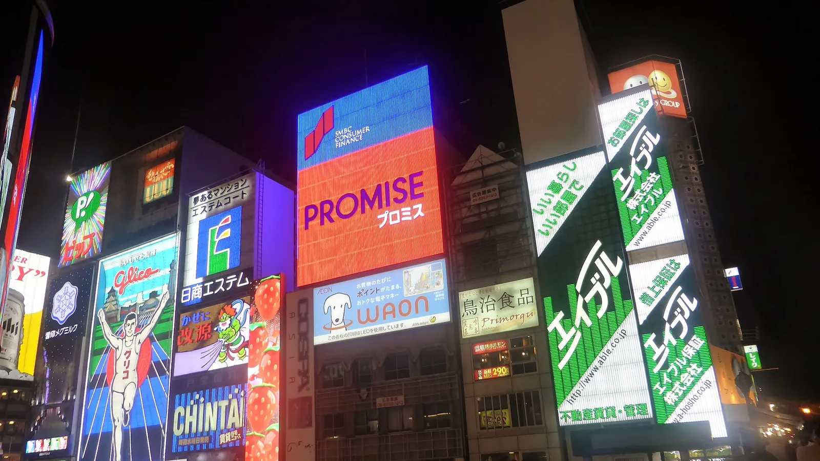 Dotonbori's neon signs reflected in the canal at night in Osaka