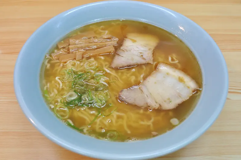 A bowl of Takayama-style ramen with thin curly noodles