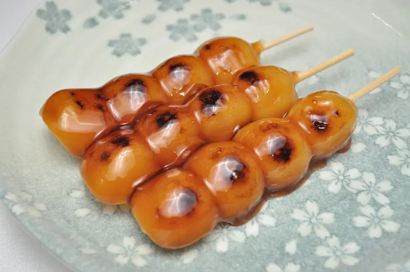 Mitarashi dango, skewered rice dumplings glazed in sweet soy sauce
