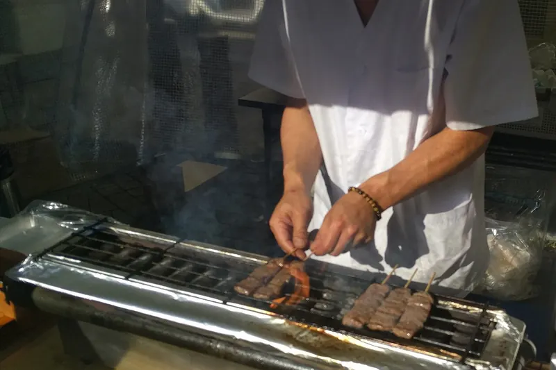 Hida beef skewers grilling at a Takayama street stall