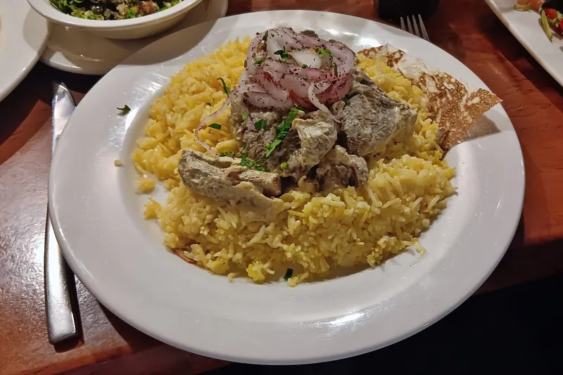 A platter of mansaf — lamb on rice and flatbread with dried-yoghurt sauce