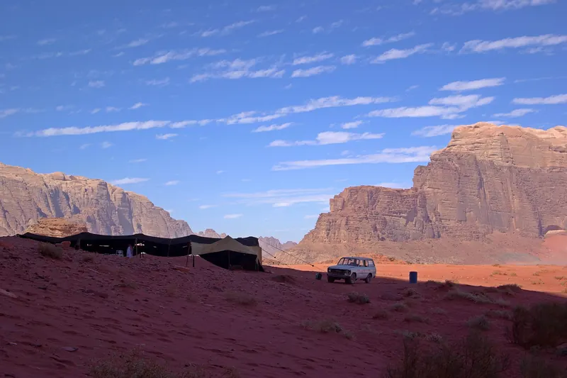 Bedouin tents pitched beneath sandstone cliffs in Wadi Rum