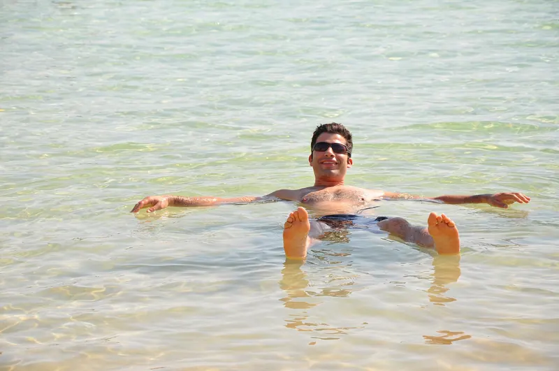 A swimmer floating effortlessly on the surface of the Dead Sea