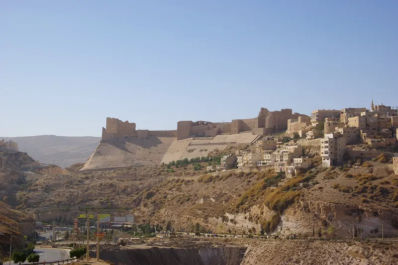 The stone walls and towers of Kerak Castle on its hilltop
