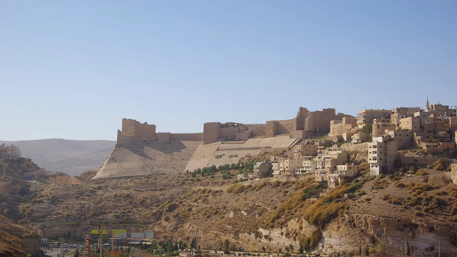 The stone walls and towers of Kerak Castle on its hilltop