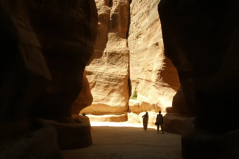 The narrow sandstone canyon of the Siq leading towards Petra