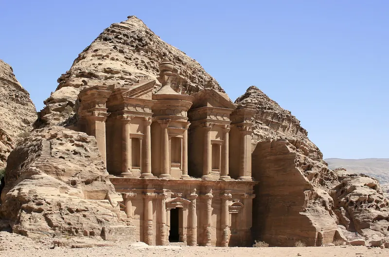 The rock-cut Monastery at Petra, framed by cliffs
