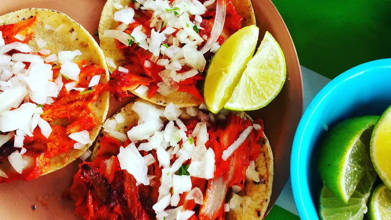Tacos al pastor served on small corn tortillas