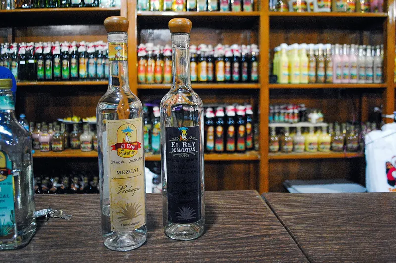 Bottles of mezcal on a shelf