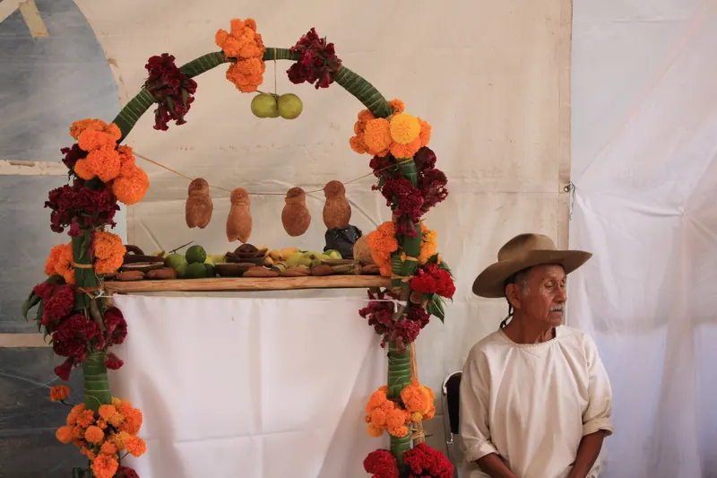 A Day of the Dead altar decorated with marigolds and candles in Oaxaca