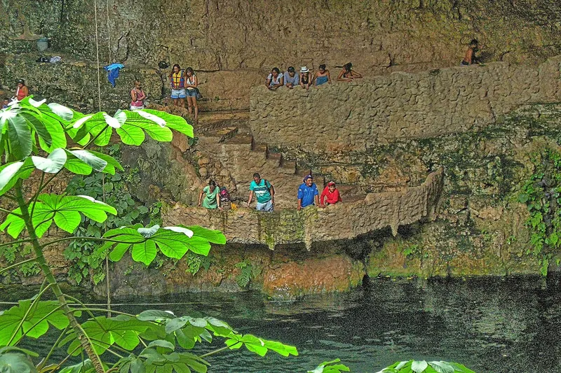 Swimmers in Cenote Zací, a limestone sinkhole in Valladolid, Yucatán