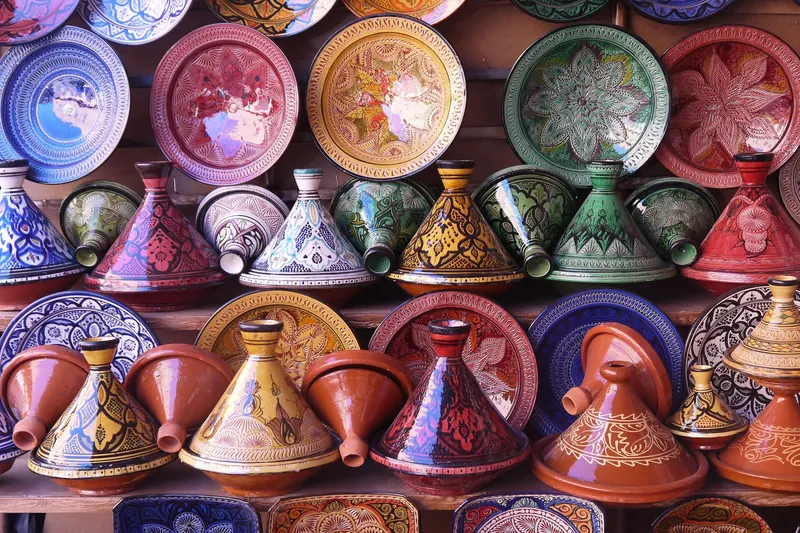 Conical clay tagine pots displayed in a Moroccan pottery shop