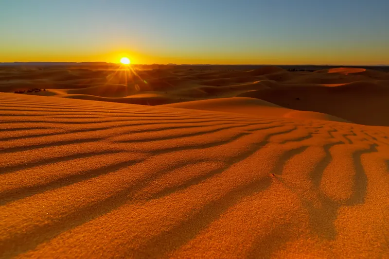 The dunes of Erg Chebbi in the Moroccan Sahara glowing at sunset