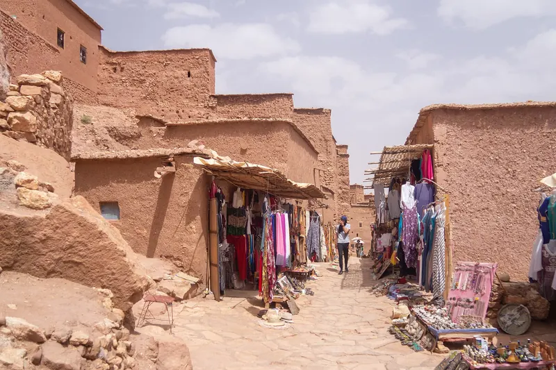 The earthen ksar of Aït Benhaddou climbing a hillside above a river in southern Morocco