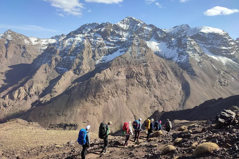 A group of hikers on a ridge below the summit of Jebel Toubkal