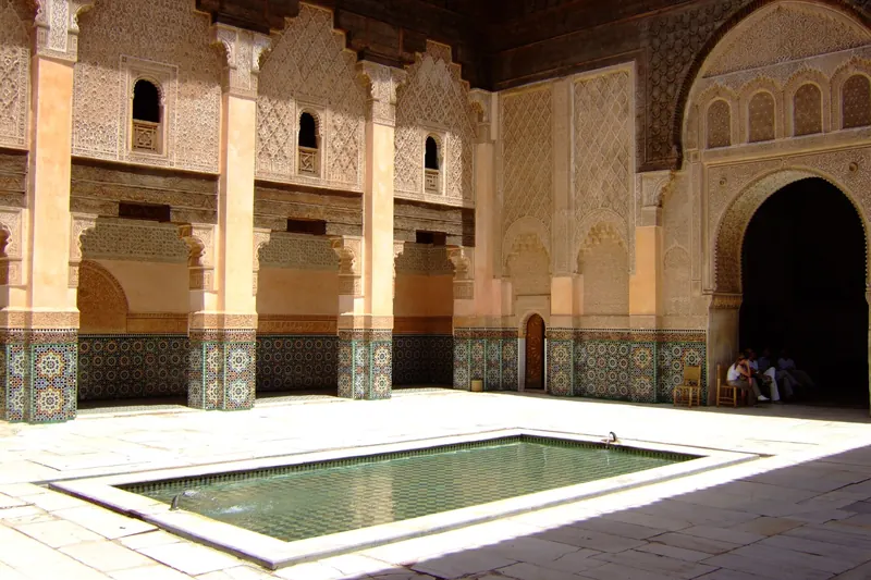 The courtyard of the Ben Youssef Madrasa with carved stucco and zellige tiles