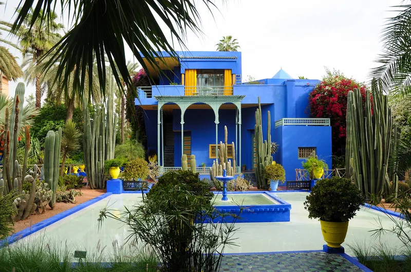 Cobalt-blue buildings among cacti and palms in the Majorelle Garden