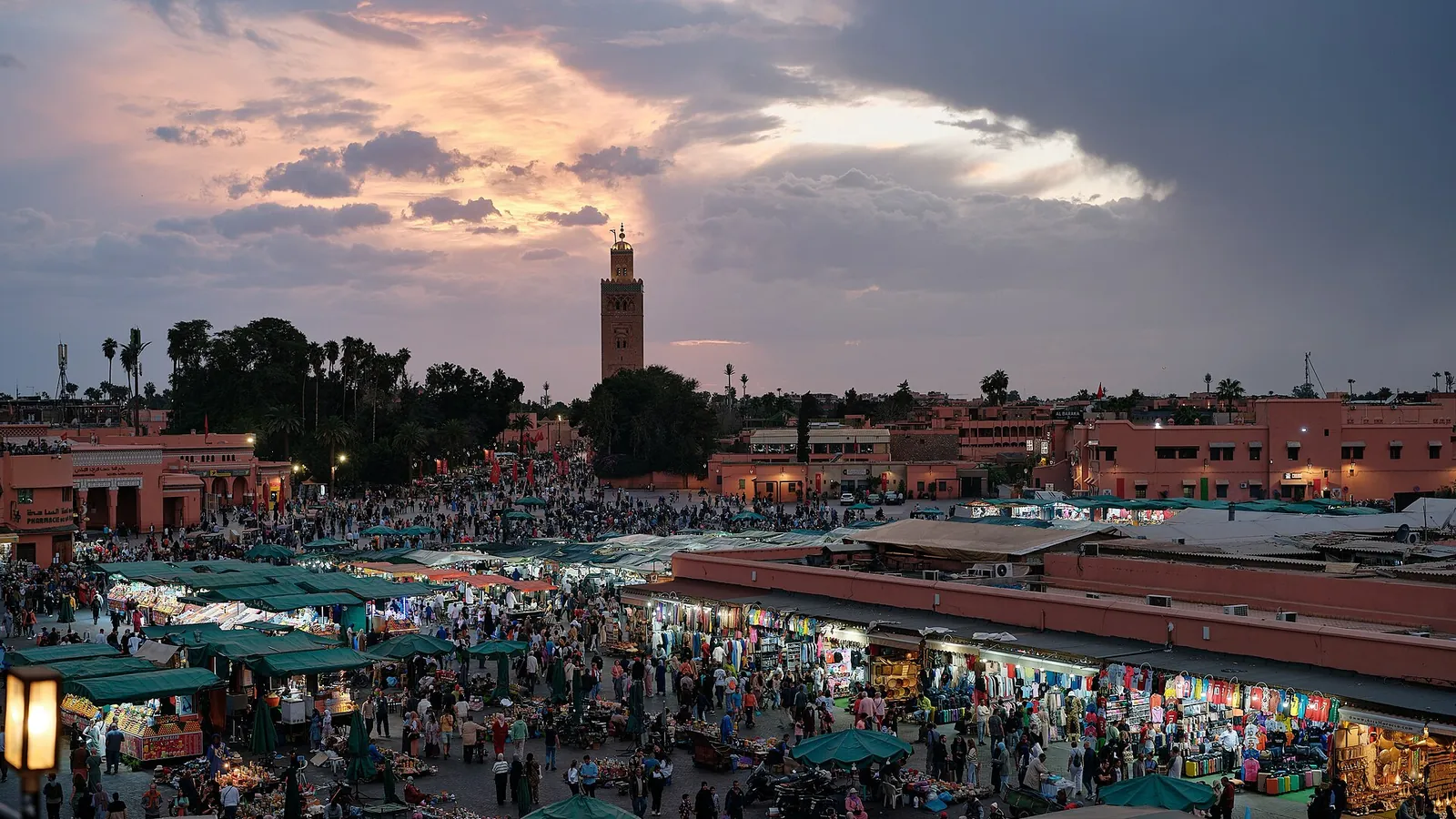 Jemaa el-Fnaa square in Marrakech at sunset with the Koutoubia minaret in the background