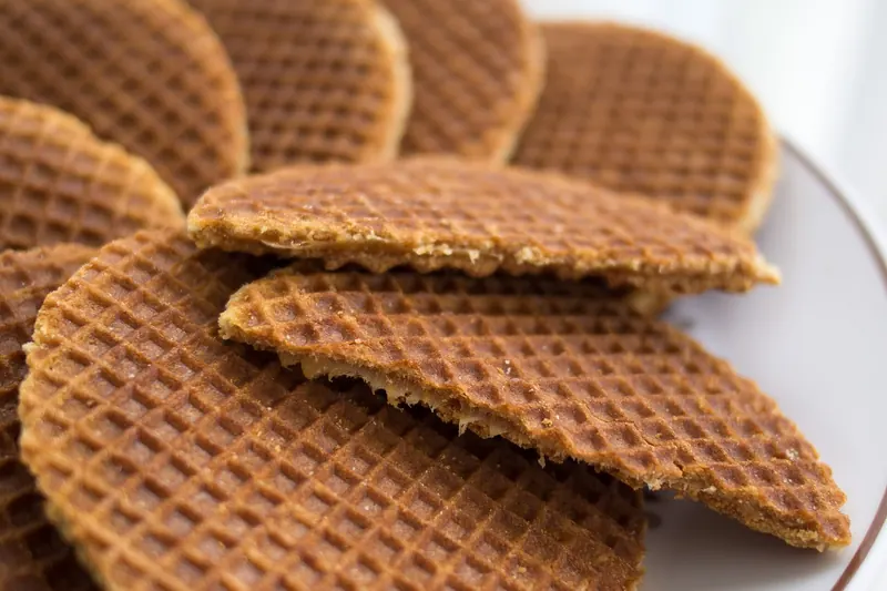 Stroopwafels, thin waffles filled with caramel syrup, stacked on a plate