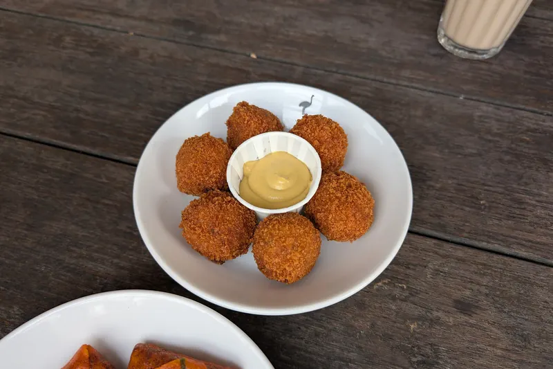 A plate of bitterballen, deep-fried Dutch meat croquettes, served with mustard