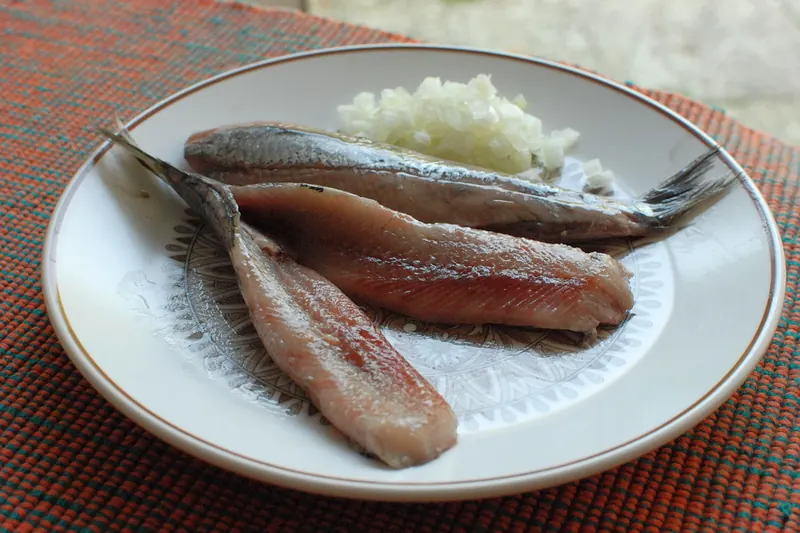 Raw Dutch herring served with chopped onion