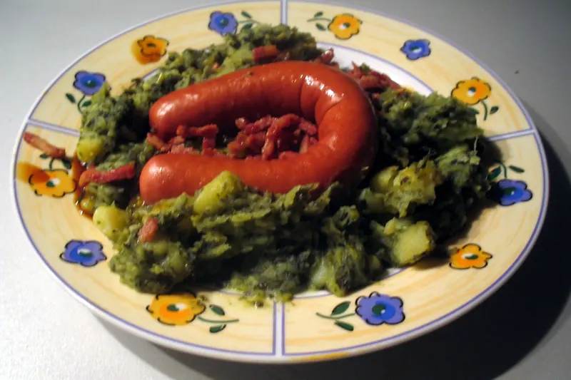 Boerenkool stamppot, mashed potato with kale, served with smoked sausage