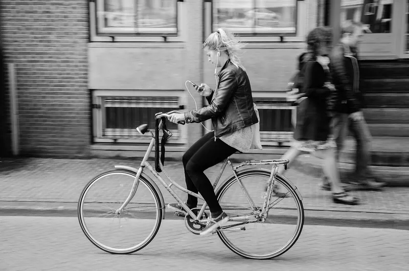 Cyclists riding a dedicated bike lane through central Amsterdam