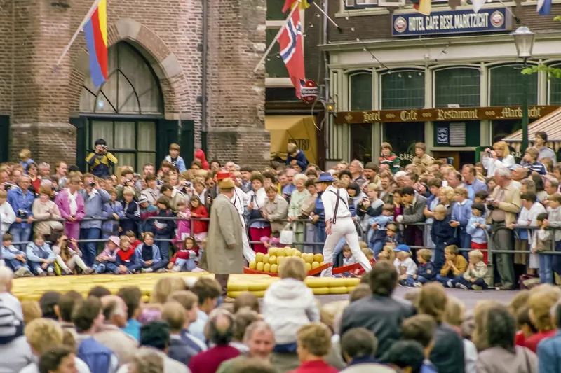 Traditional cheese carriers and a crowd at the historic Alkmaar cheese market