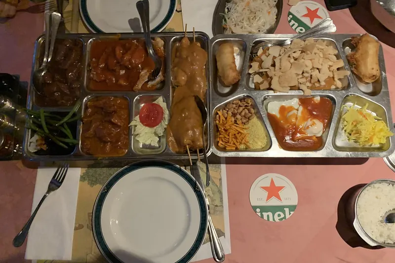 A rijsttafel spread of small Indonesian dishes