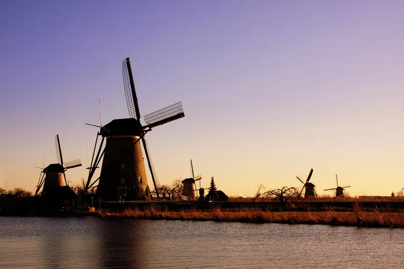 The windmills of Kinderdijk silhouetted at sunset