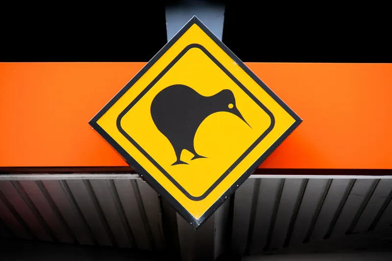 A yellow kiwi crossing warning sign, an iconic sight on New Zealand roads