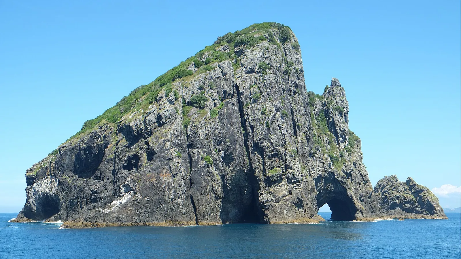 The Hole in the Rock, a natural arch through Motukokako Island in the Bay of Islands